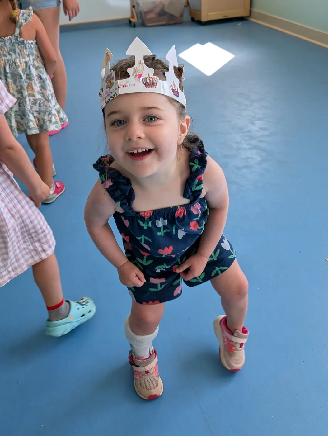 A happy preschooler wearing a handmade crown at Blossom Station